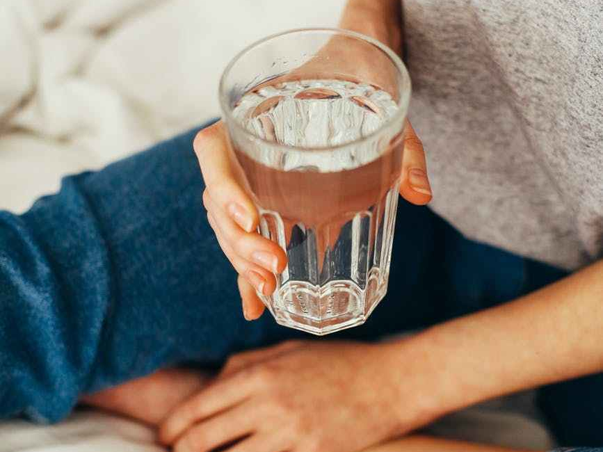 person holding drinking cup sitting